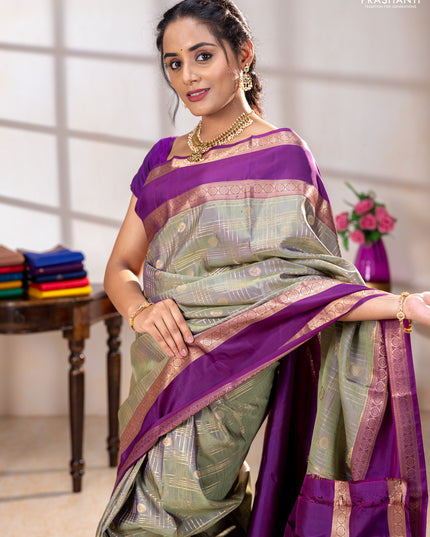 Pure kanchipuram silk saree pastel green and purple with allover zari checks& buttas and rettapet zari woven border