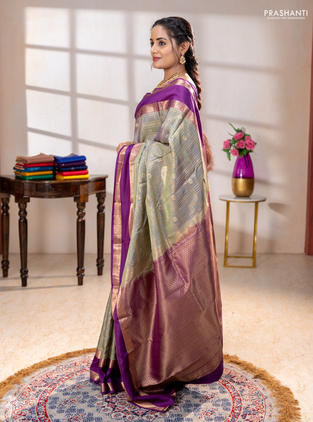 Pure kanchipuram silk saree pastel green and purple with allover zari checks& buttas and rettapet zari woven border