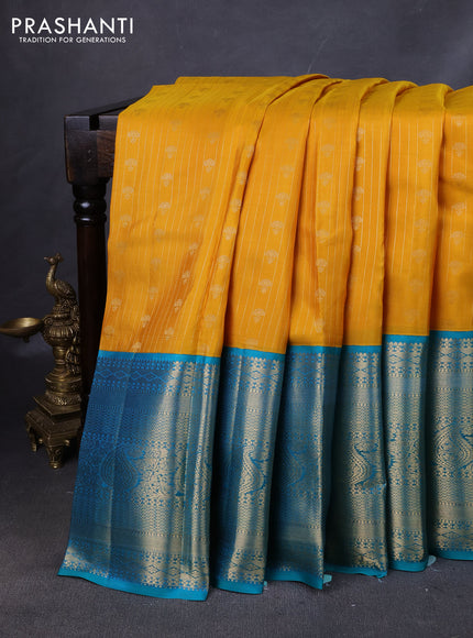 Pure kanchipuram silk saree yellow and teal green with allover zari stripes & buttas and long zari woven korvai border