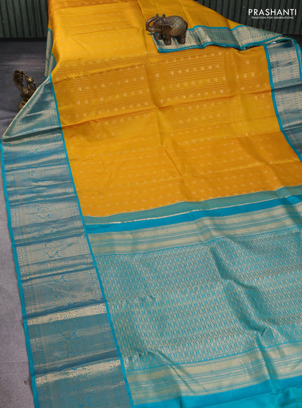 Pure kanchipuram silk saree yellow and teal green with allover zari stripes & buttas and long zari woven korvai border