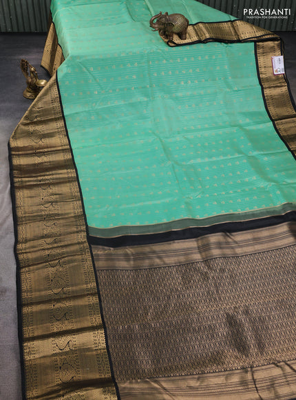 Pure kanchipuram silk saree teal green and black with allover zari stripes & buttas and long zari woven korvai border