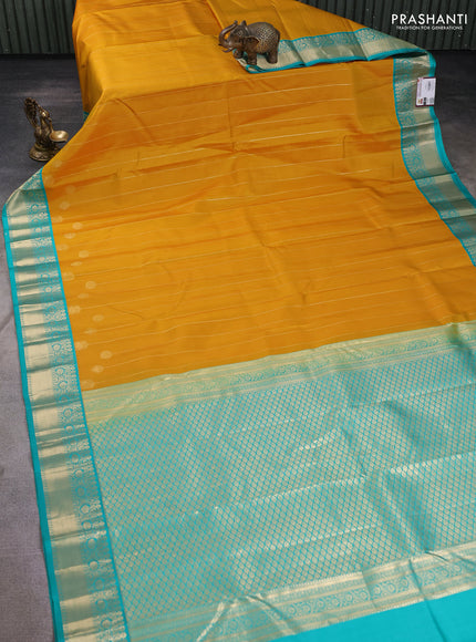 Pure kanchipuram silk saree yellow and teal green with allover zari stripes pattern and zari woven korvai border