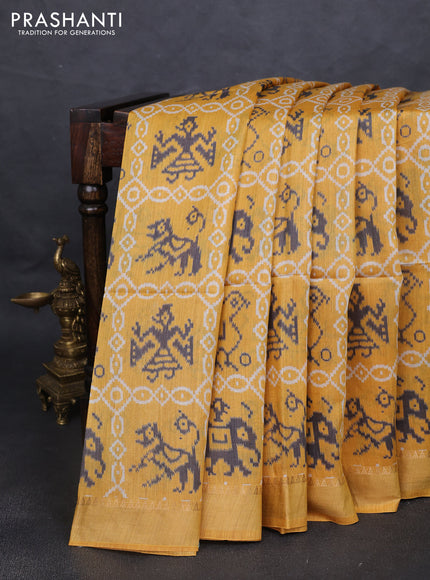 Munga tussar silk saree mustard yellow with allover patola prints and zari woven border