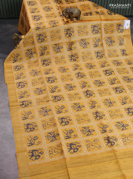 Munga tussar silk saree mustard yellow with allover patola prints and zari woven border