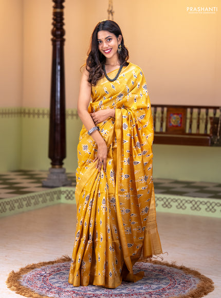 Munga tussar silk saree yellow with allover ikat butta prints and zari woven border