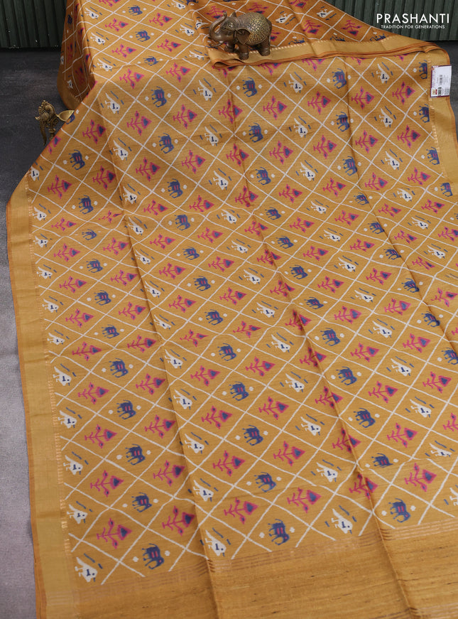 Munga tussar silk saree dark mustard with allover patola prints and zari woven border