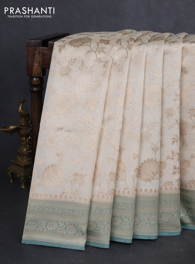 Banarasi silk cotton saree cream and pastel green shade with allover floral zari weaves and zari woven border