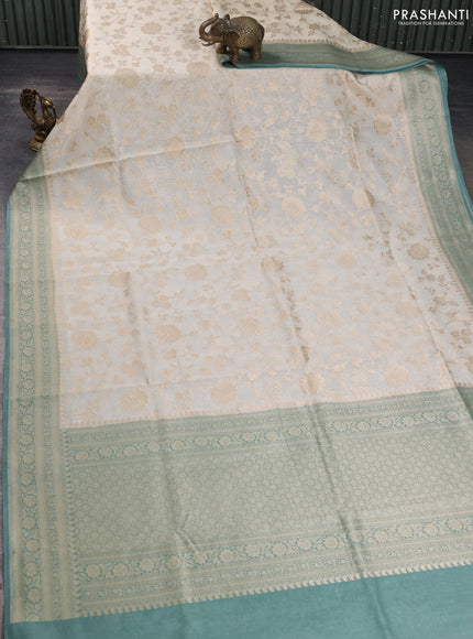 Banarasi silk cotton saree cream and pastel green shade with allover floral zari weaves and zari woven border