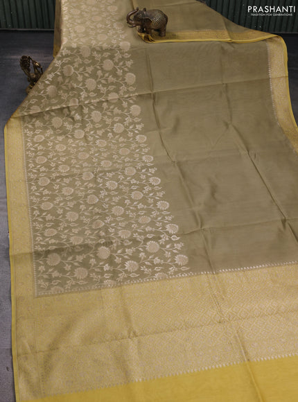 Banarasi silk cotton saree beige and yellow with allover zari woven buttas and zari woven border