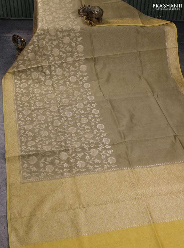 Banarasi silk cotton saree beige and yellow with allover zari woven buttas and zari woven border