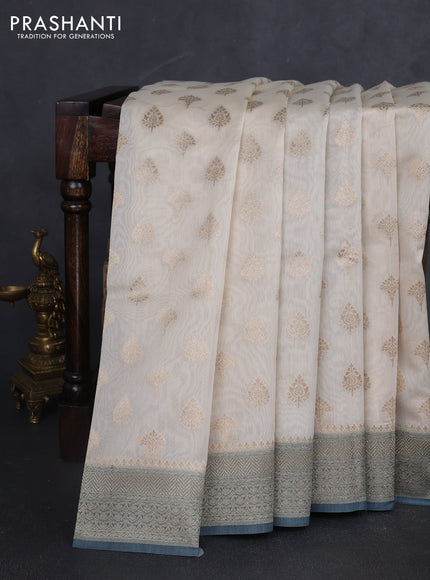 Banarasi silk cotton saree cream and bluish grey with allover zari woven buttas and zari woven border