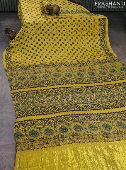 Modal silk saree yellow with allover ajrak butta prints and zari woven pallu