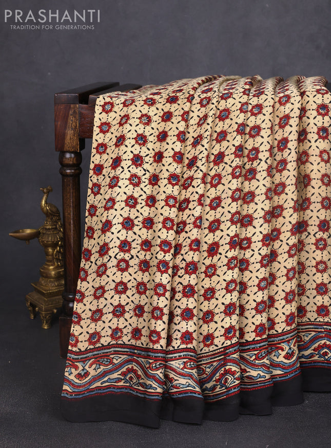 Modal silk saree cream and black with allover ajrak butta prints and zari woven pallu