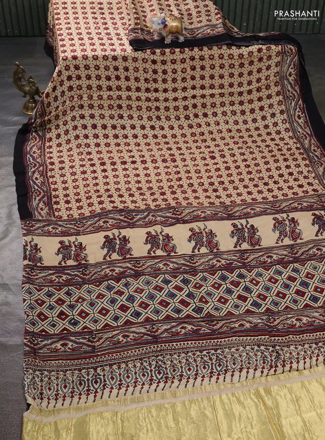 Modal silk saree cream and black with allover ajrak butta prints and zari woven pallu