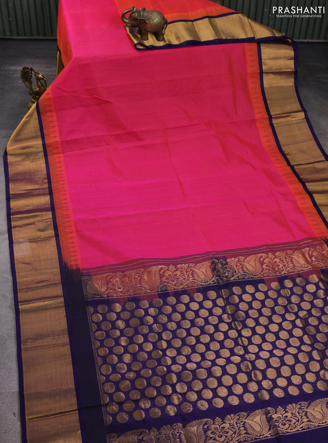 Kuppadam silk cotton saree dual shade of pinkish orange and navy blue with plain body and temple design zari woven border