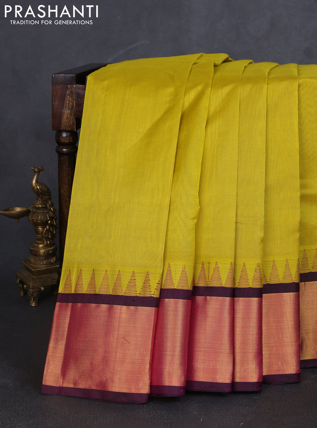 Kuppadam silk cotton saree lime yellow and deep jamun with plain body and temple design zari woven border