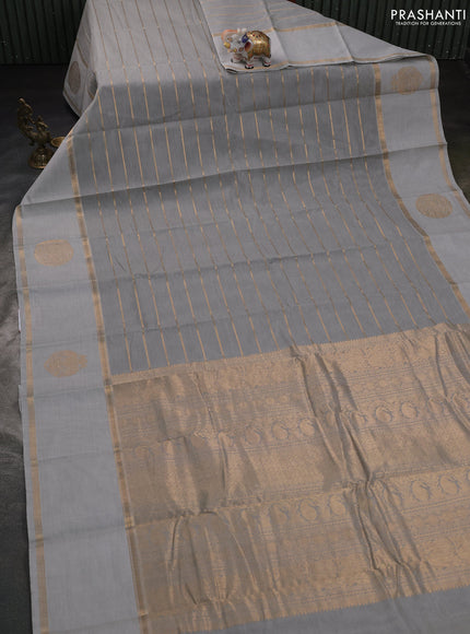 Kanchi cotton saree pastel grey with allover zari weaves and rettapet zari woven border