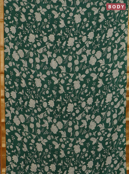 Muslin silk saree green and dark mustard with allover floral prints and zari woven border