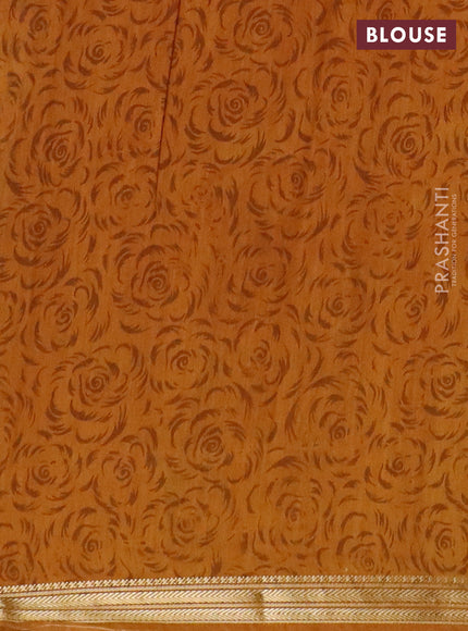 Muslin silk saree green and dark mustard with allover floral prints and zari woven border