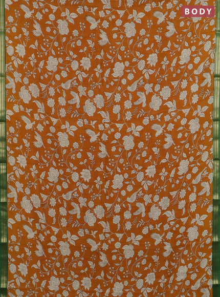 Muslin silk saree dark mustard and green with allover floral prints and zari woven border