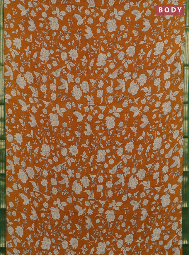 Muslin silk saree dark mustard and green with allover floral prints and zari woven border