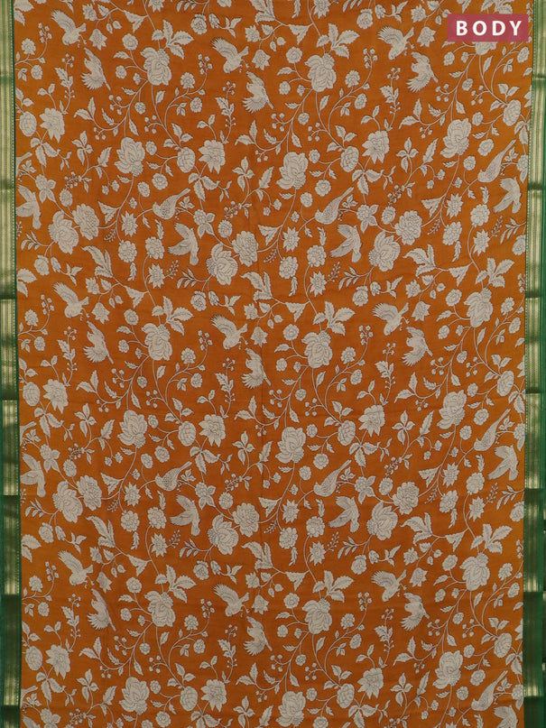 Muslin silk saree dark mustard and green with allover floral prints and zari woven border