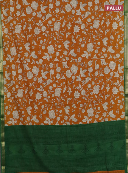 Muslin silk saree dark mustard and green with allover floral prints and zari woven border