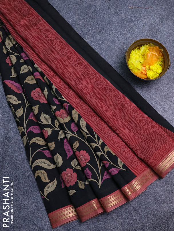 Muslin silk saree black and peach shade with allover prints and zari woven border