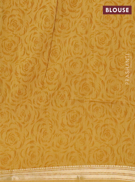 Muslin silk saree green and mustard yellow with allover prints and zari woven border
