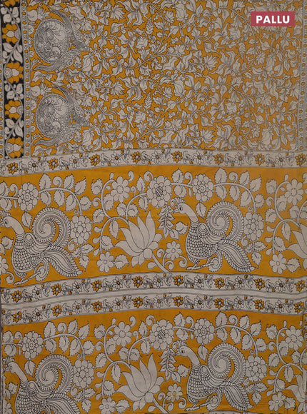 Kalamkari cotton saree yellow and black with allover prints and printed border