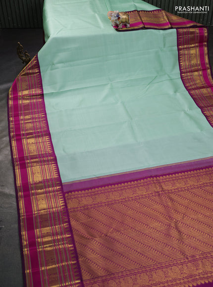 Pure kanchipuram silk saree teal shade and purple with plain body and long zari woven korvai border