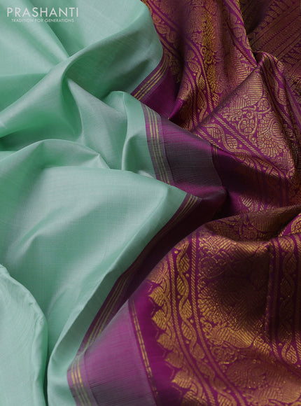 Pure kanchipuram silk saree teal shade and purple with plain body and long zari woven korvai border