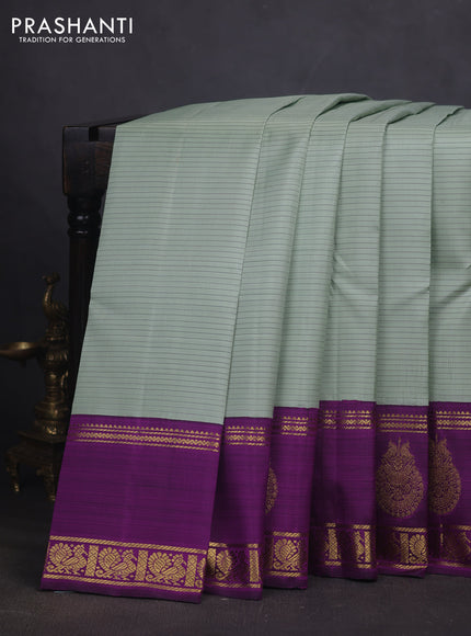 Pure kanchipuram silk saree pastel green and purple with allover stripe pattern and rich zari woven butta border