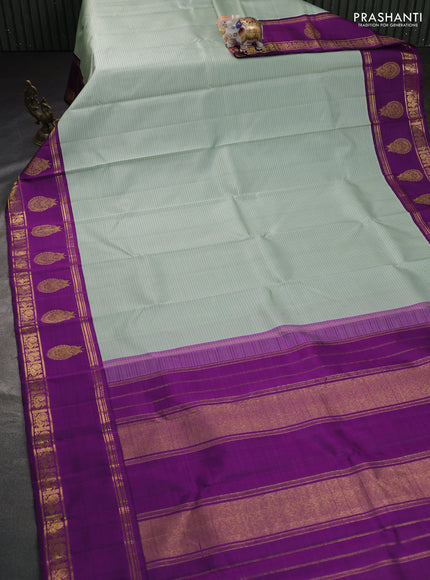 Pure kanchipuram silk saree pastel green and purple with allover stripe pattern and rich zari woven butta border