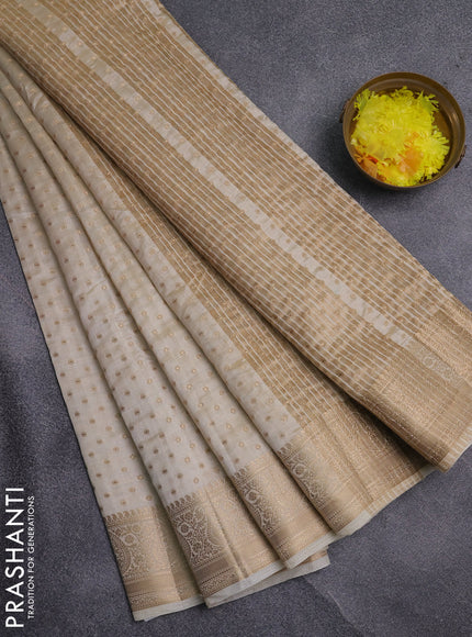 Semi raw silk saree cream with allover zari woven 1000 buttas and zari woven border