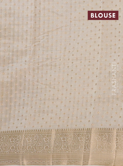 Semi raw silk saree cream with allover zari woven 1000 buttas and zari woven border