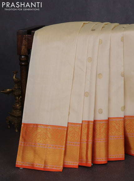 Pure kanchipuram silk saree cream and orange with zari woven buttas and rich zari woven korvai border