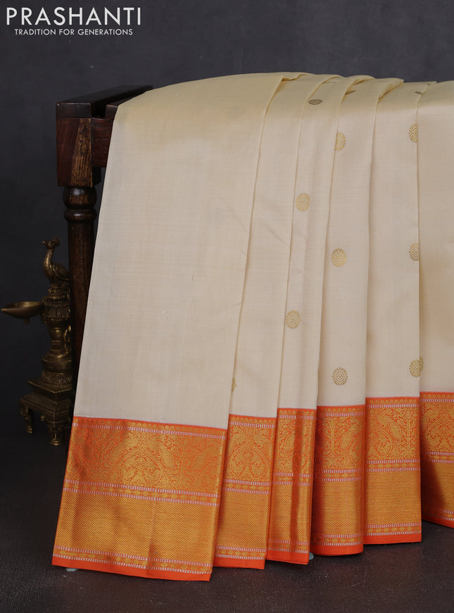 Pure kanchipuram silk saree cream and orange with zari woven buttas and rich zari woven korvai border