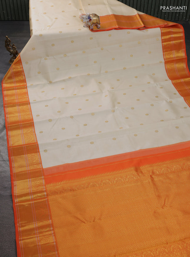 Pure kanchipuram silk saree cream and orange with zari woven buttas and rich zari woven korvai border