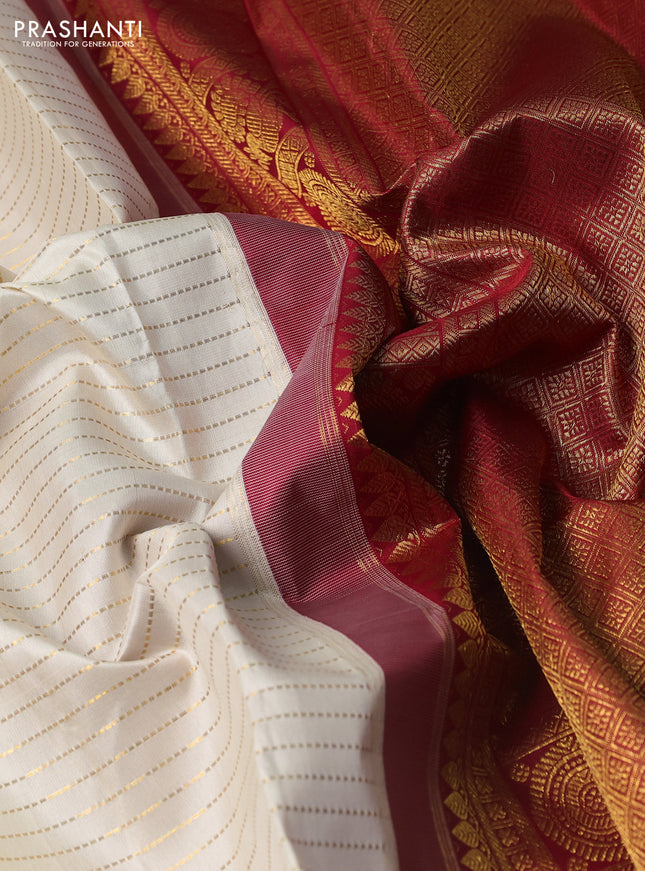 Pure kanchipuram silk saree cream and maroon with allover zari stripe weaves and zari woven korvai border