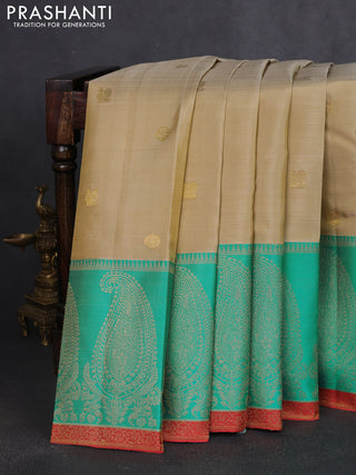 Pure kanchipuram silk saree beige and teal blue with zari woven buttas and long paisley zari woven border