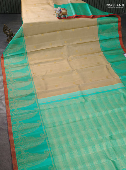 Pure kanchipuram silk saree beige and teal blue with zari woven buttas and long paisley zari woven border