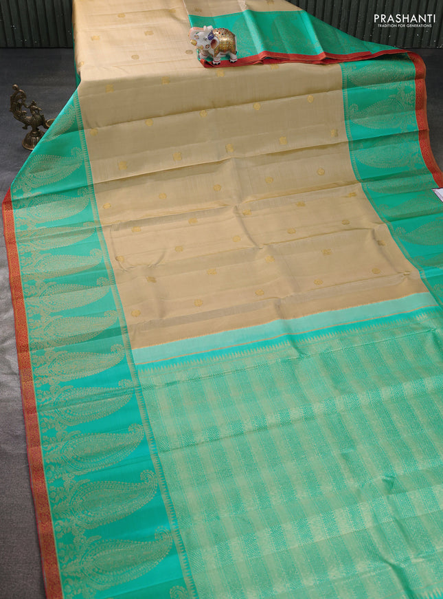 Pure kanchipuram silk saree beige and teal blue with zari woven buttas and long paisley zari woven border