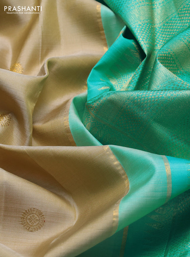 Pure kanchipuram silk saree beige and teal blue with zari woven buttas and long paisley zari woven border