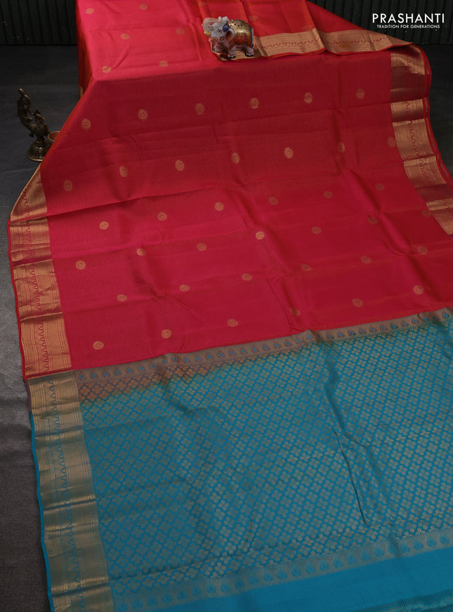 Kanchipuram silk saree dual shade of pinkish orange and teal green with allover zari weaves & buttas and zari woven border
