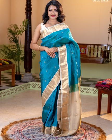 Kanchipuram silk saree dual shade of teal bluish green and cream with allover zari weaves and zari woven korvai border