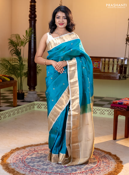 Kanchipuram silk saree dual shade of teal bluish green and cream with allover zari weaves and zari woven korvai border