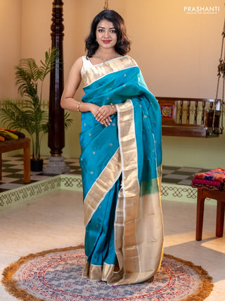 Kanchipuram silk saree dual shade of teal bluish green and cream with allover zari weaves and zari woven korvai border