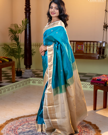 Kanchipuram silk saree dual shade of teal bluish green and cream with allover zari weaves and zari woven korvai border