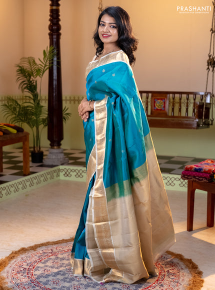 Kanchipuram silk saree dual shade of teal bluish green and cream with allover zari weaves and zari woven korvai border